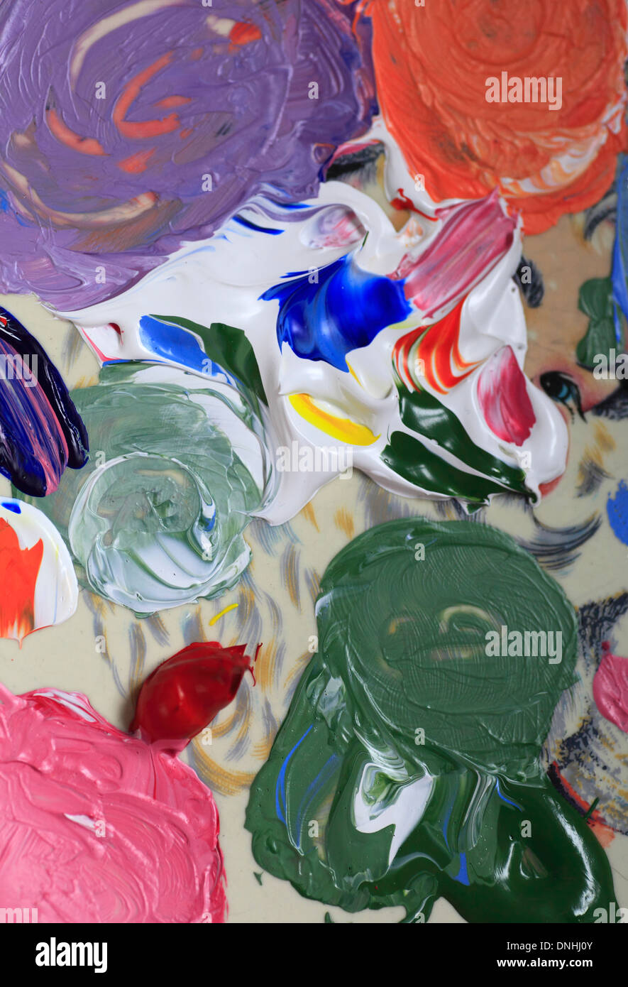 Paints on a palette during artwork. Stock Photo