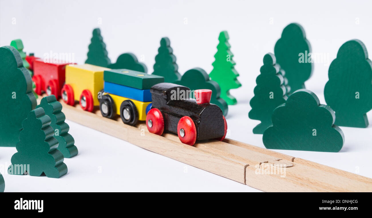 black wooden toy train in rural landscape made with simple toy trees Stock Photo