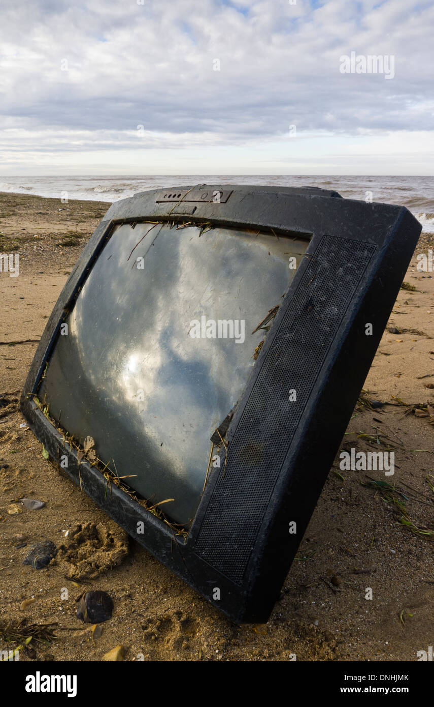 Television set washed up on a beach. Stock Photo