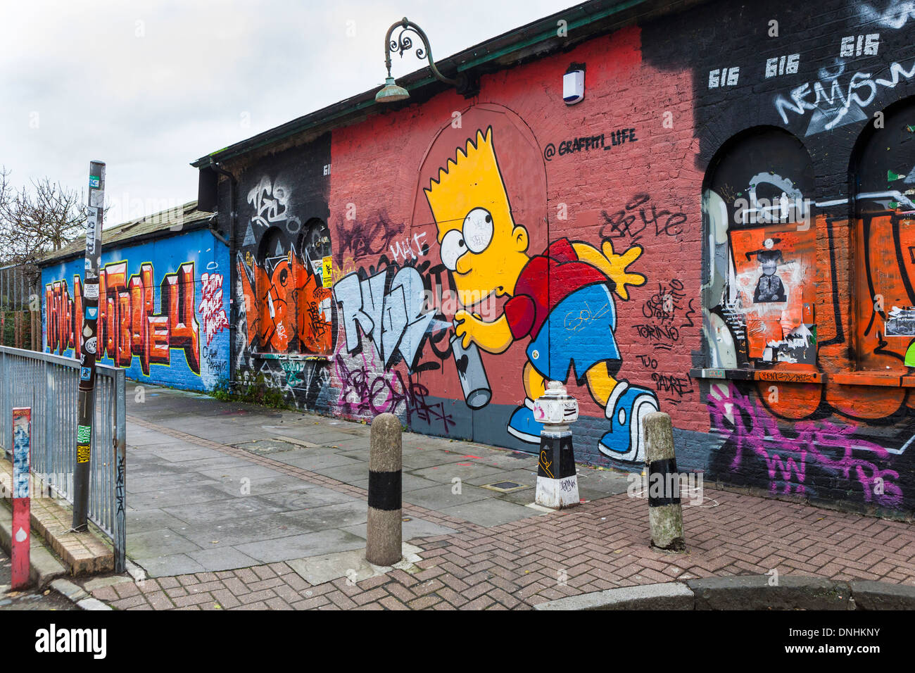 Street art and graffiti tags - Homer Simpson using spray can paint - Pedley street, off Brick lane, East London, UK Stock Photo
