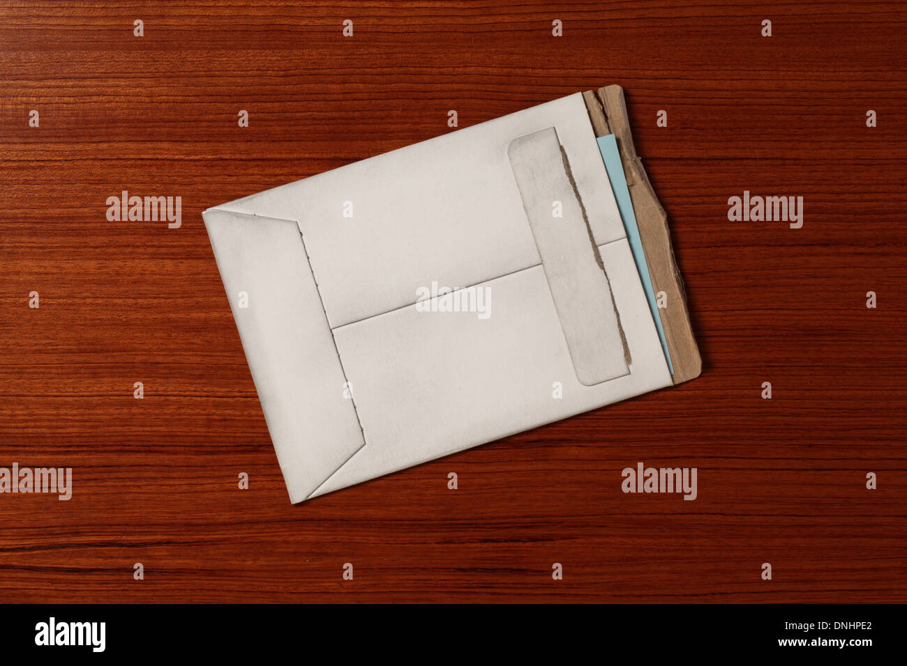 An air mail postage envelope slightly worn and torn on a wood surface Stock Photo Alamy