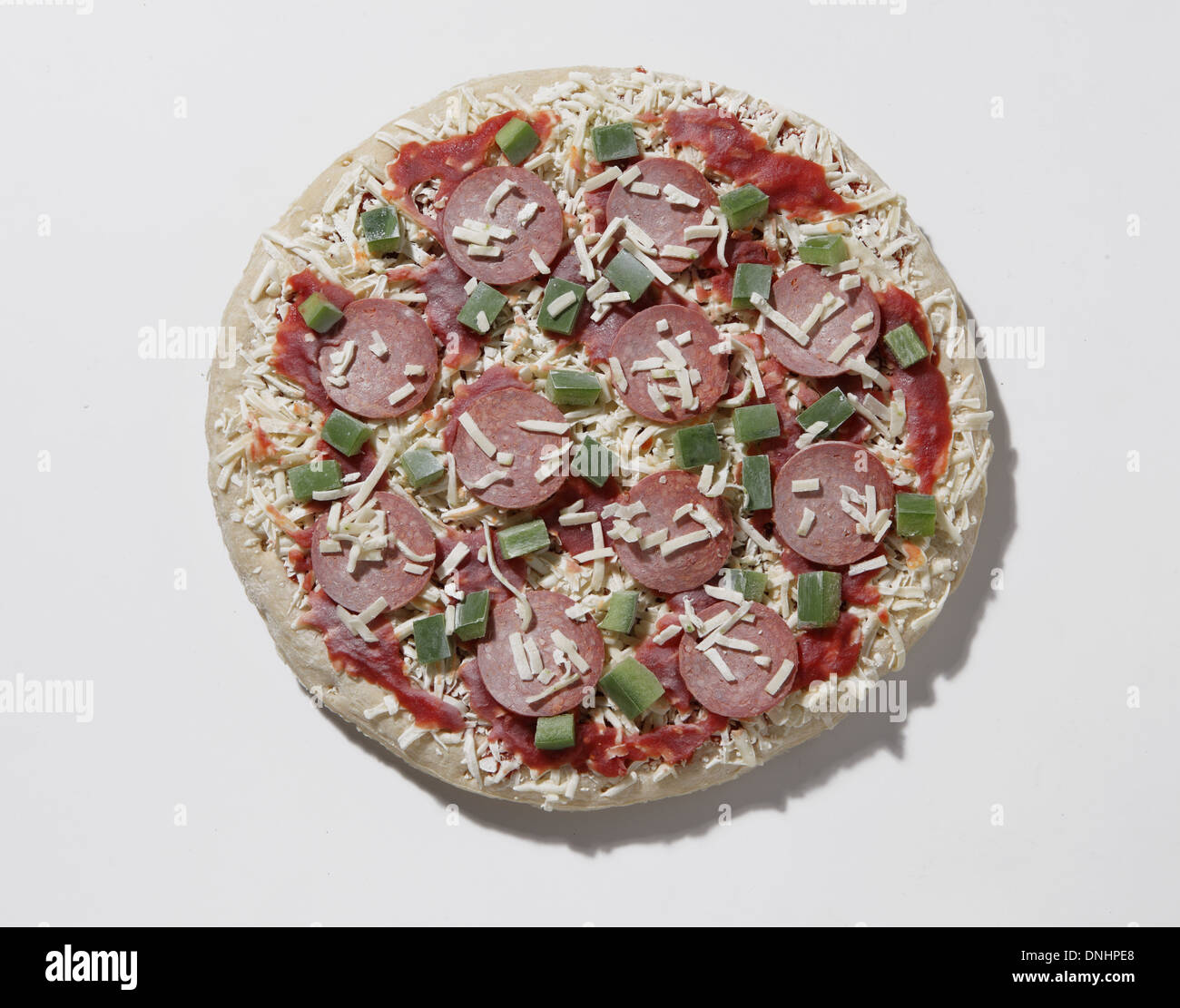 A round uncooked frozen pizza. Stock Photo