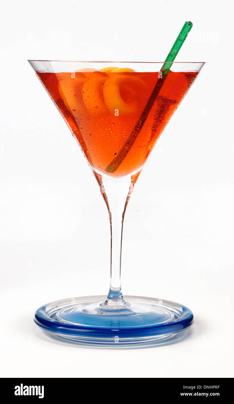 A colorful cocktail drink in a glass with a orange twist garnish. Stock Photo