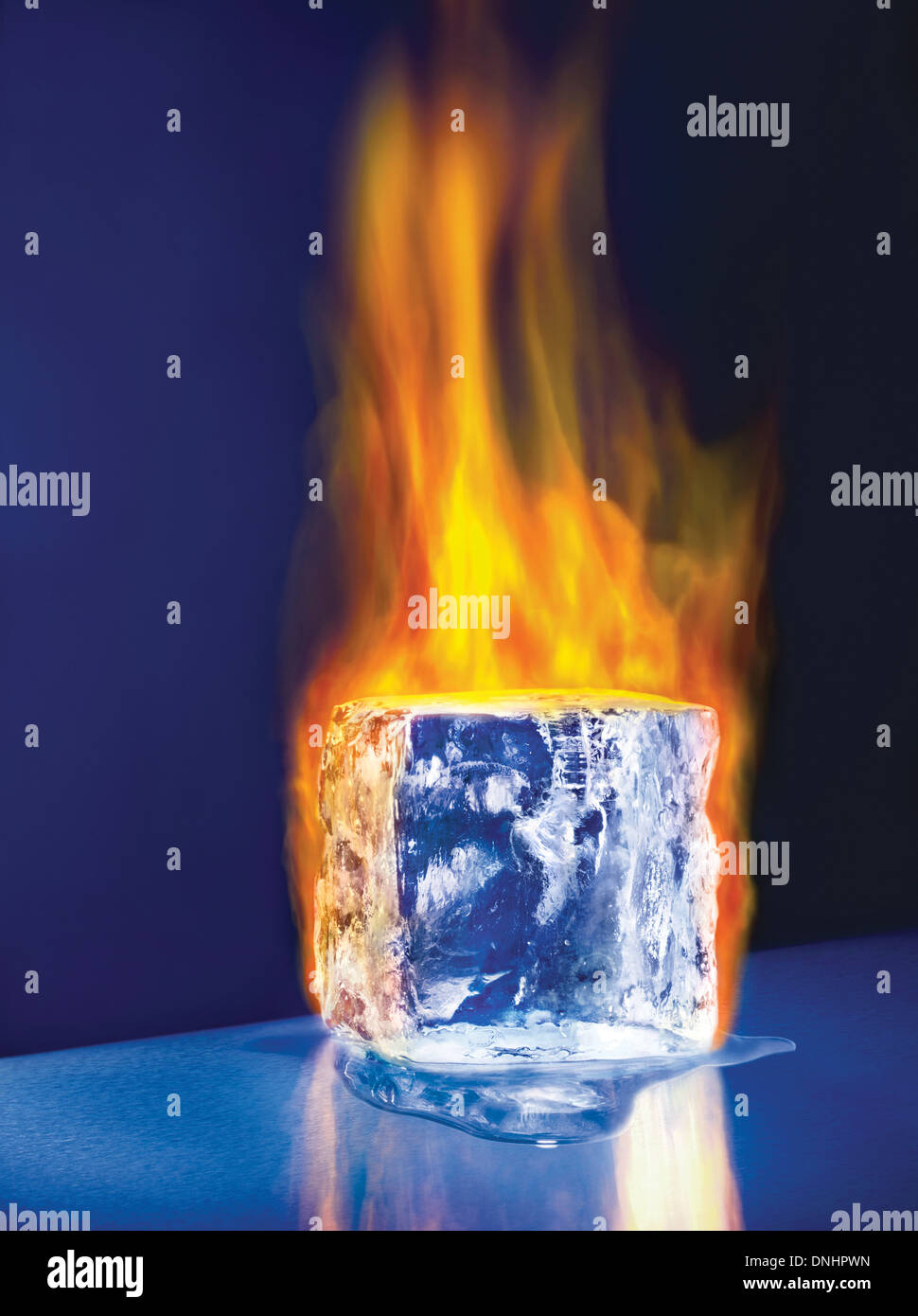 A large melting ice block cube on fire. Stock Photo