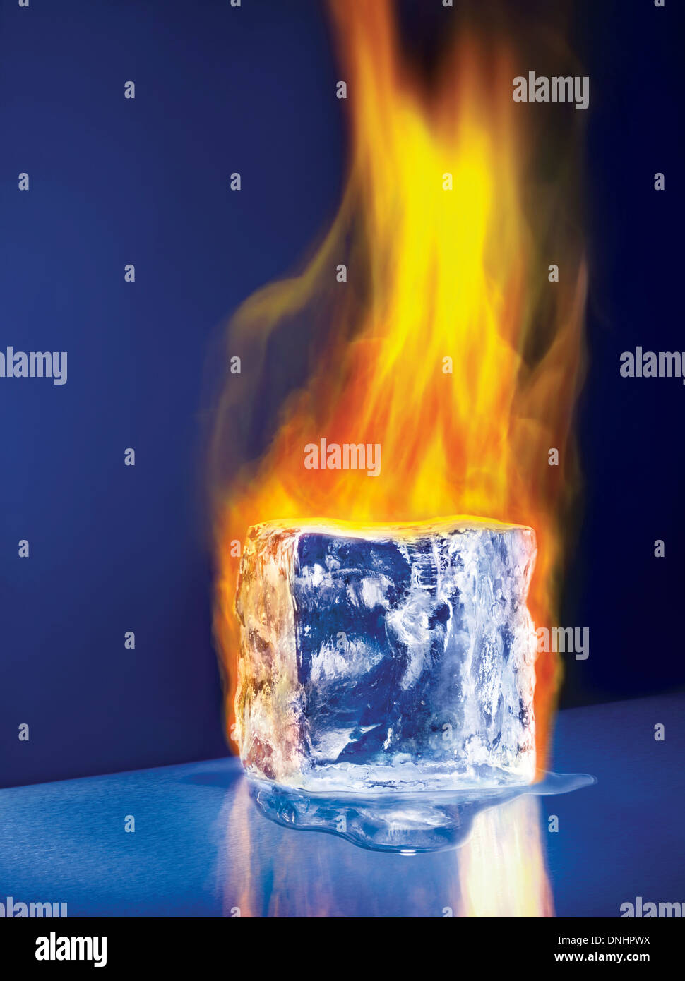 A large melting ice block cube on fire. Stock Photo