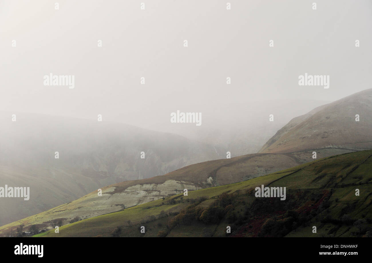 Wintery shower falling in hills, Cumbria, UK. Stock Photo