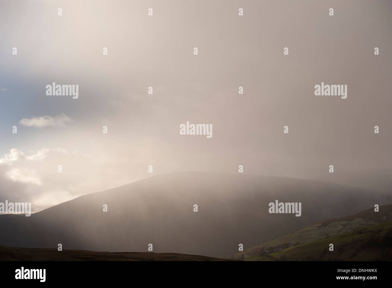 Wintery shower falling in hills, Cumbria, UK. Stock Photo