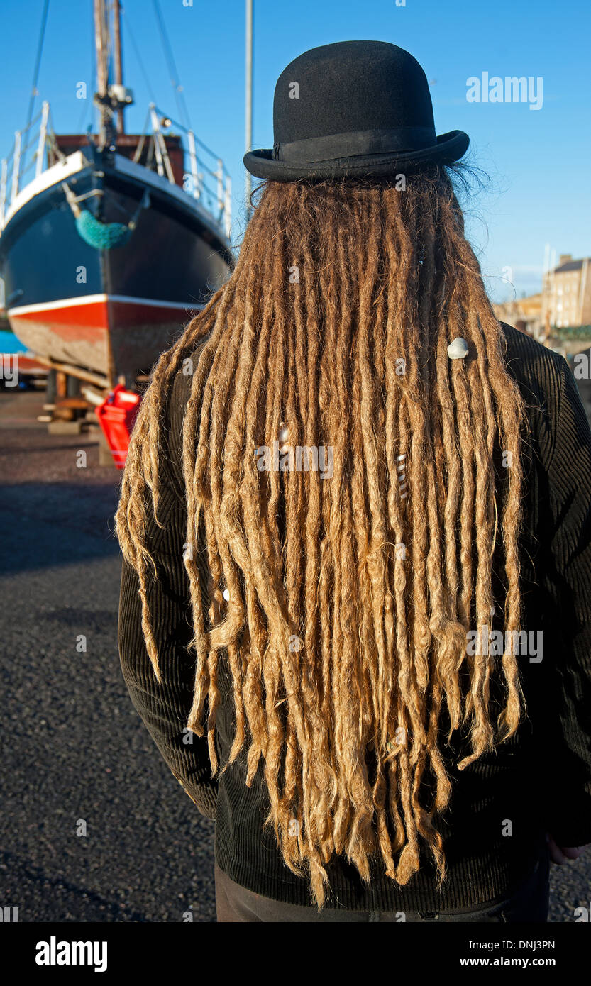 Hair wear Rastafarian, young Ducthman at Burghead Harbour, Moray. Scotland.   SCO 9158 Stock Photo
