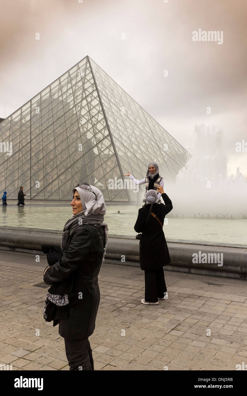 pyramide du louvre paris.tourists posing for portraits outside entrance to louvre gallery paris france. Stock Photo