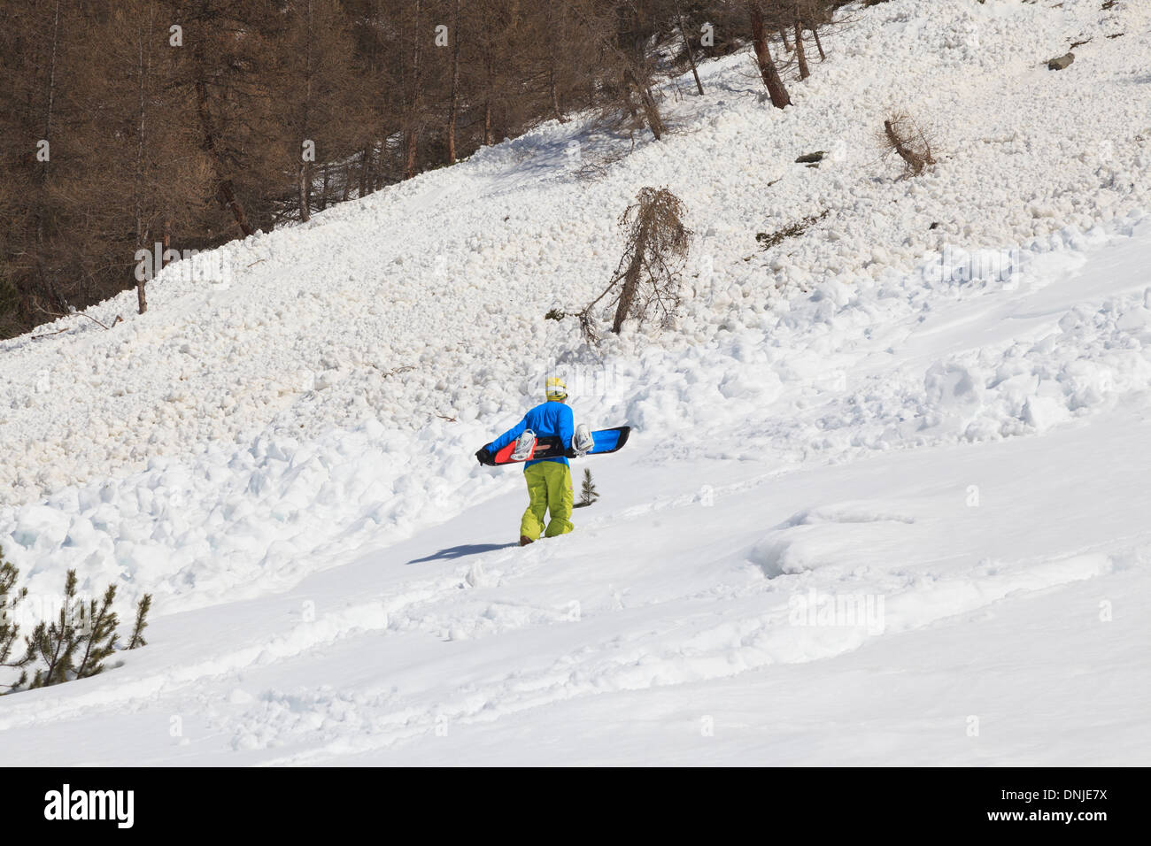 Climbing uphill before some radical snowboarding action Stock Photo