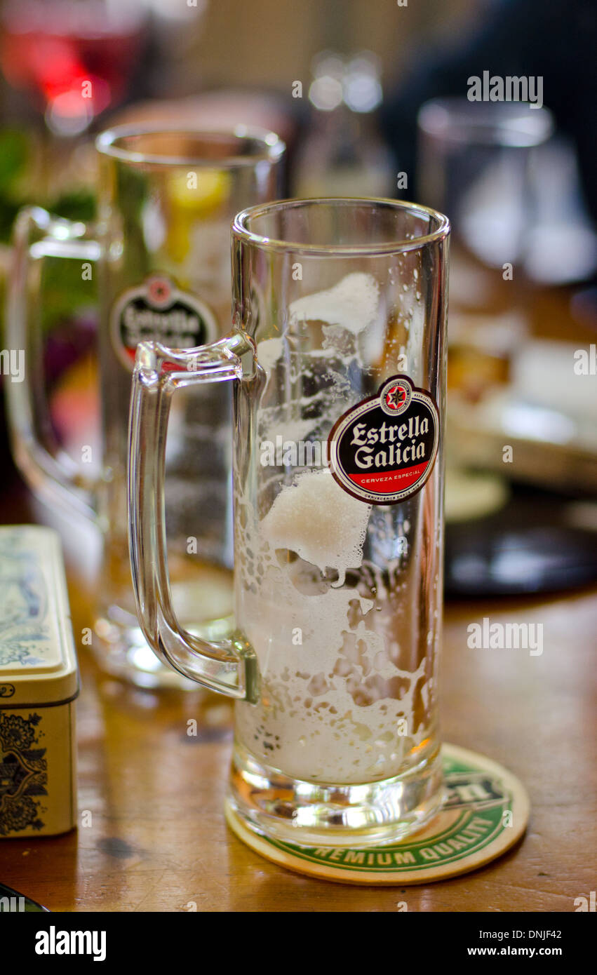 Empty glass of Estrella Galicia a brand of pale lager beer from spain on a  coaster Stock Photo - Alamy