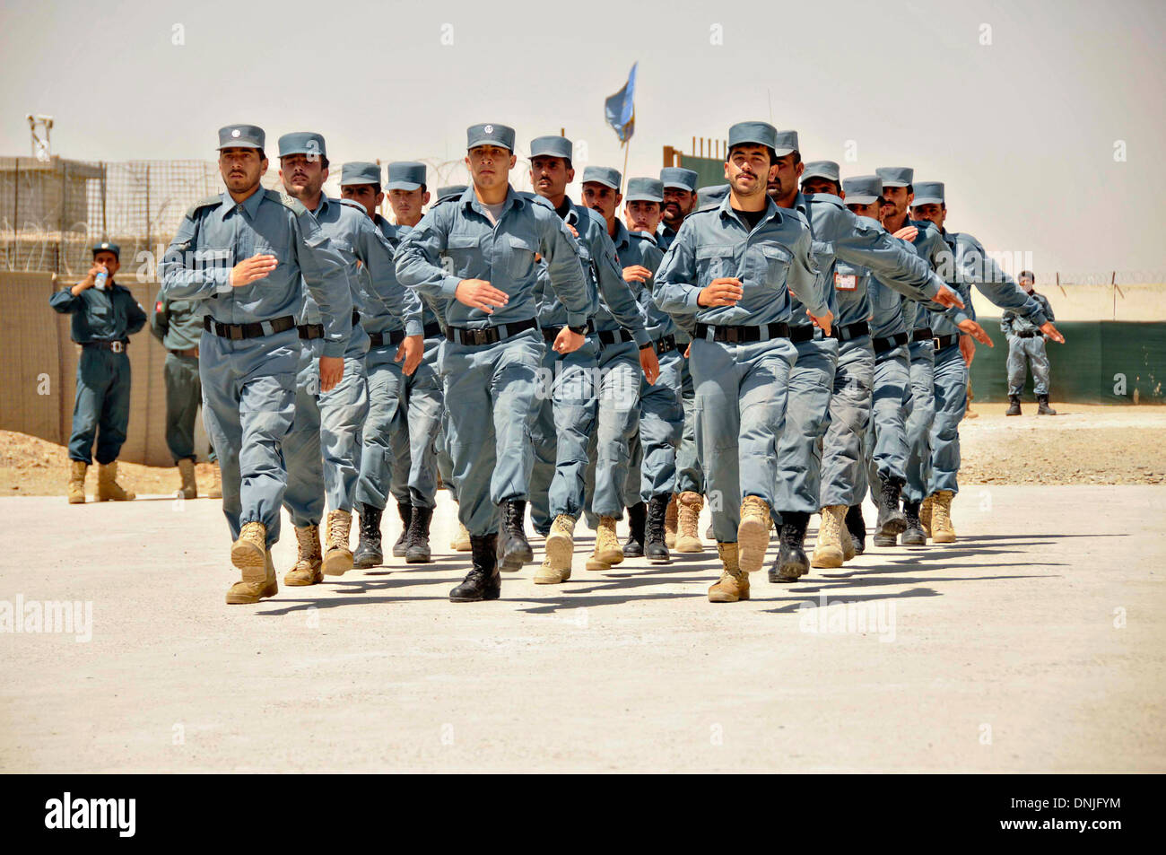 Afghan National Police officers march during an Afghan Local Police graduation ceremony at the regional ALP training center June 6, 2013 in the Lashkar Gah district, Helmand province, Afghanistan. Stock Photo