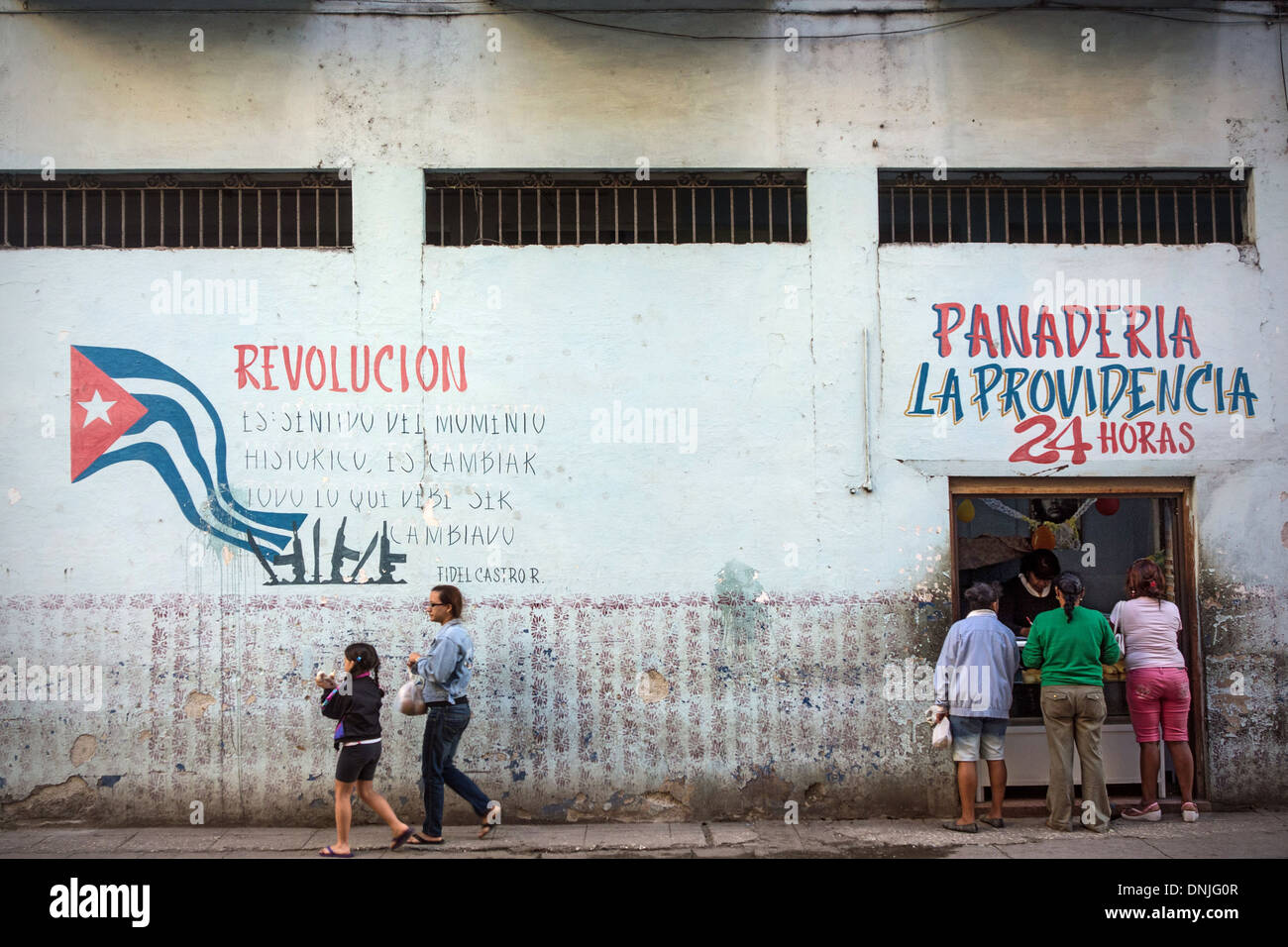 POLITICAL GRAFFITI ABOUT THE CUBAN REVOLUTION (REVOLUCION) ON THE WALL OF A PANADERIA, STATE BAKERY ACCEPTING RATION CARDS, STREET SCENE AND DAILY LIFE, HAVANA, CUBA, THE CARIBBEAN Stock Photo