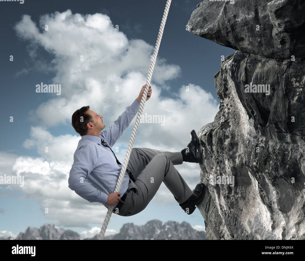 Businessman climbing mountain Stock Photo