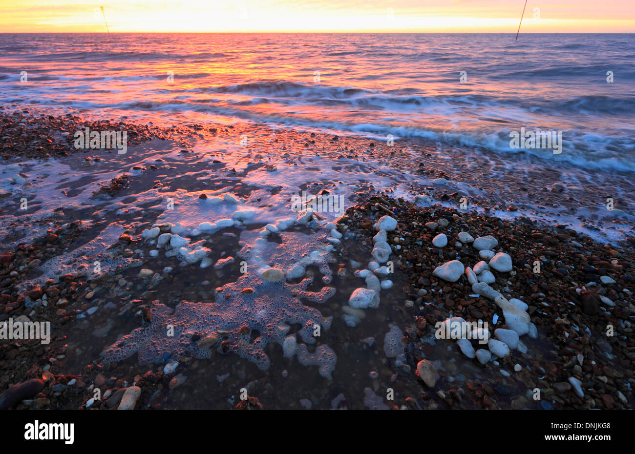 The sun set on New Year's Eve 2013 at Heacham, Norfolk, with '2013' spelt out in white stones. Stock Photo