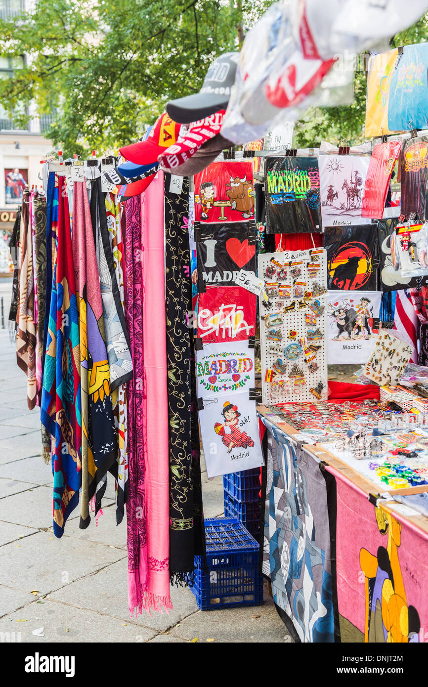 View of typical colourful roadside souvenir stall in Madrid, Spain, selling pashminas, baseball caps, scarves and t-shirts Stock Photo