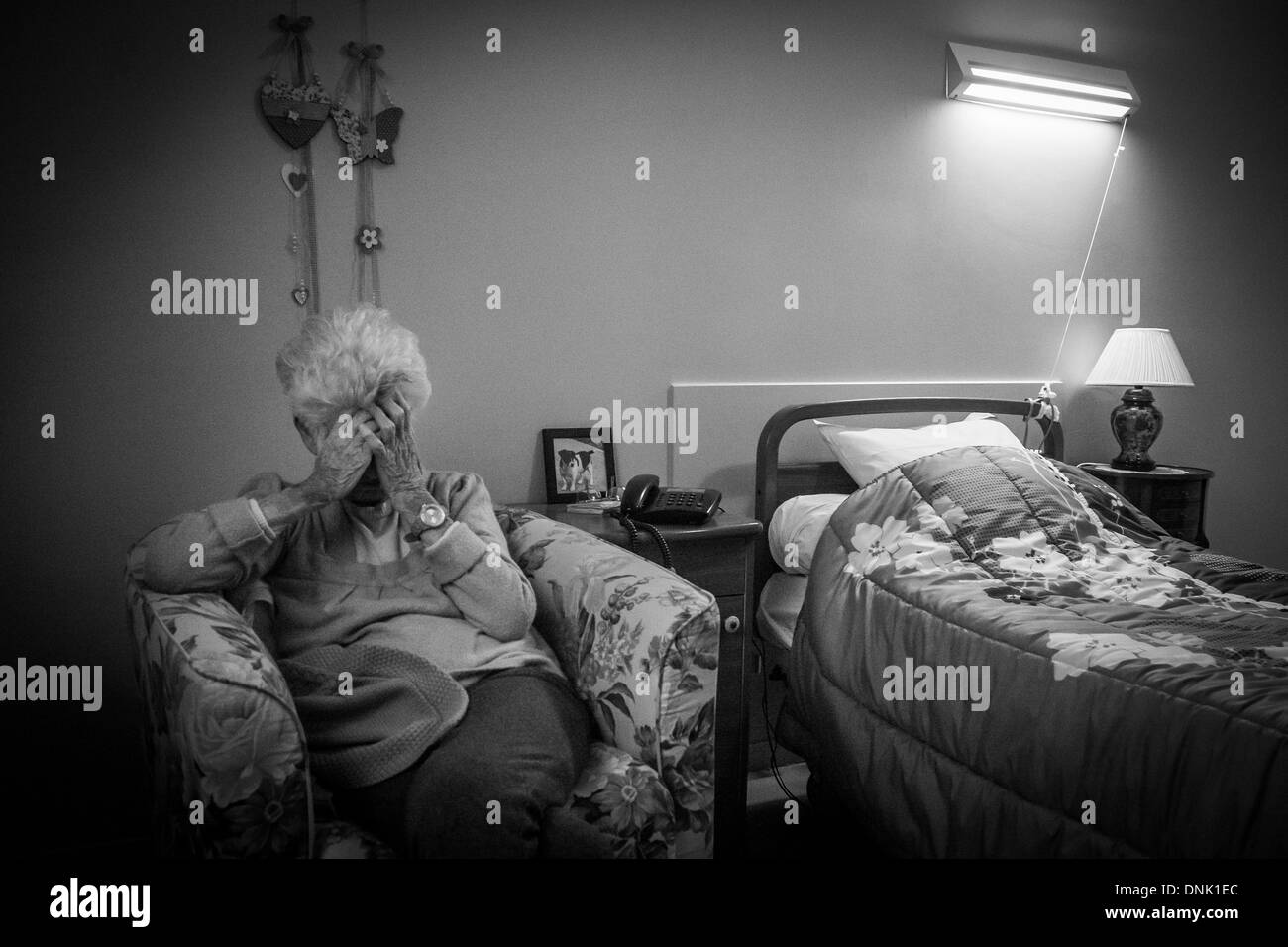 RETIREMENT HOME ILLUSTRATION, ELDERLY PERSON IN A BEDROOM SUFFERING FROM LONELINESS Stock Photo