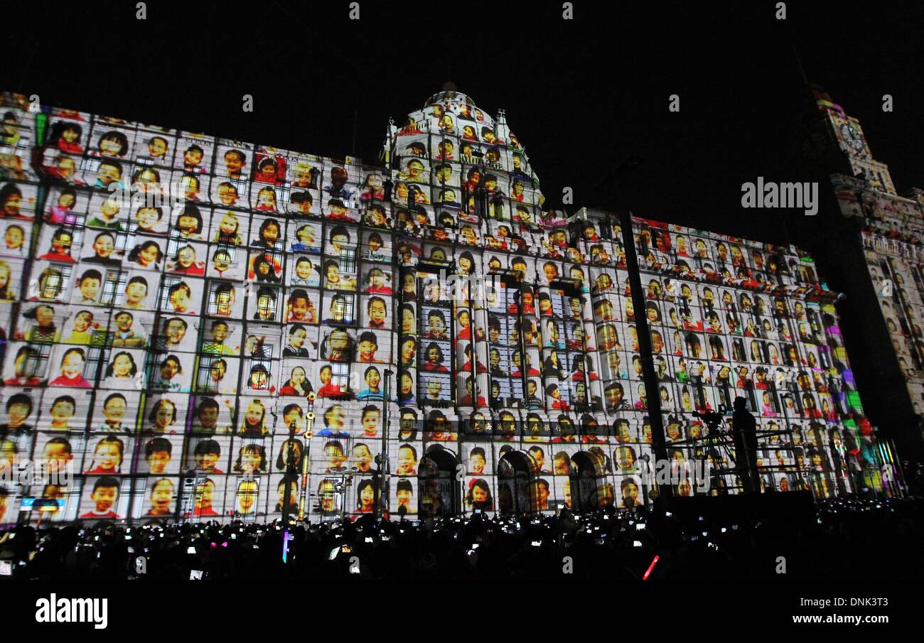 Shanghai, China. 31st December 2013. Children's portraits are projected on a building during a count-down event for the new year at the Bund, east China's Shanghai, Dec. 31, 2013. Credit:  Ding Ding/Xinhua/Alamy Live News Stock Photo