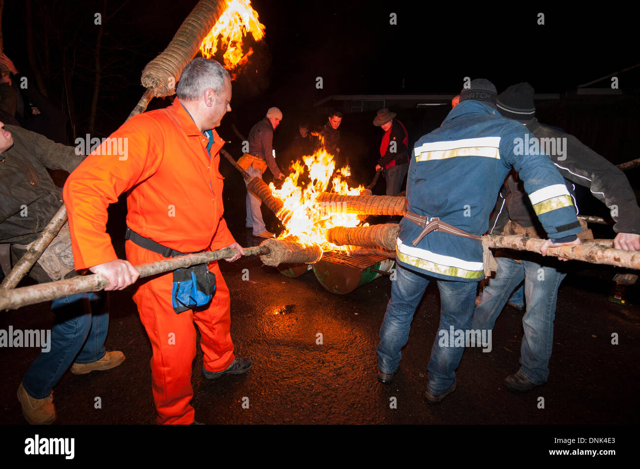 Comrie, Scotland, UK. 1st January 2014. The Flambeaux Procession is a fiery torch procession around the village of Comrie ending with the torches being ceremoniously thrown in the River Earn. Visitors came from all over the place to watch it and it gave a unique atmosphere. Credit:  Andrew Steven Graham/Alamy Live News Stock Photo