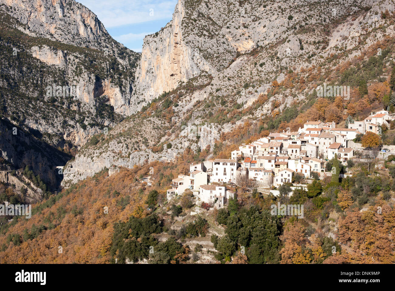 AERIAL VIEW. Perched medieval village at the entrance of a deep canyon. Aiglun, Esteron Valley, Alpes-Maritimes, French Riviera's backcountry, France. Stock Photo