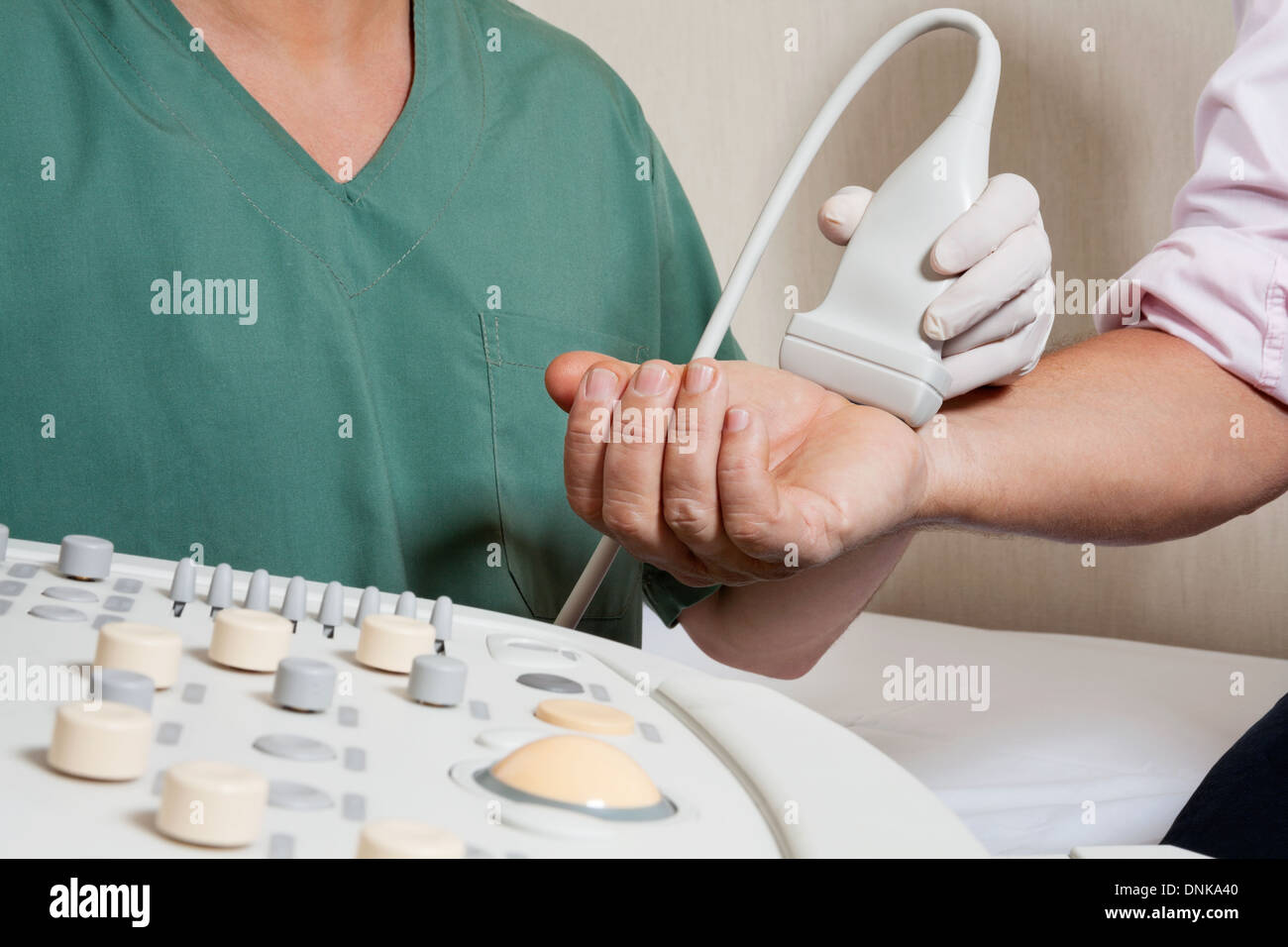 Technician Scanning Male Patient's Hand Stock Photo - Alamy