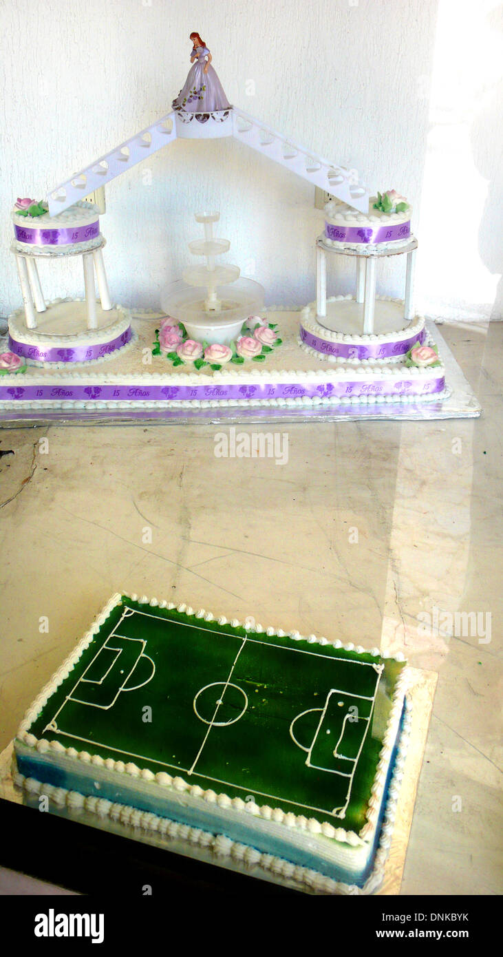 A cake decorated as a soccer field, below, and another decorated for a coming-of-age party for a fifteen year old girl called 'Q Stock Photo