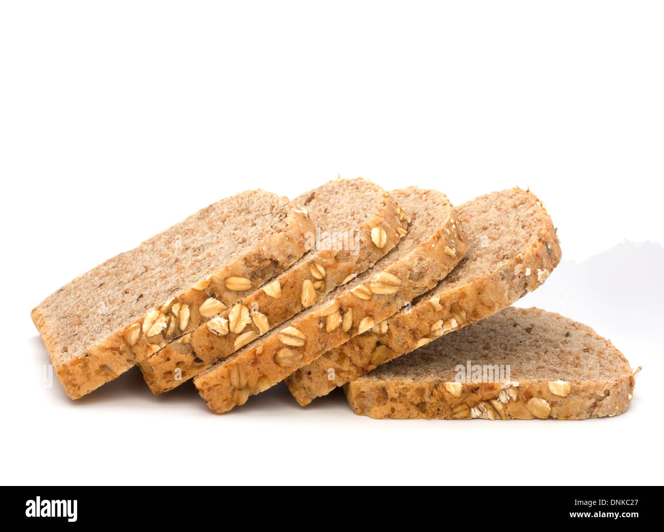 Healthy bran bread slices with rolled oats isolated on white background Stock Photo