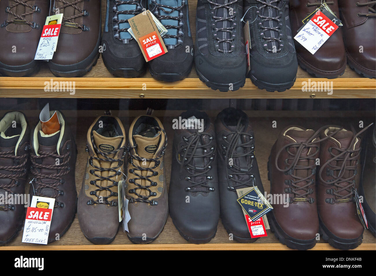 Walking boots for sale in outdoor clothing shop Stock Photo