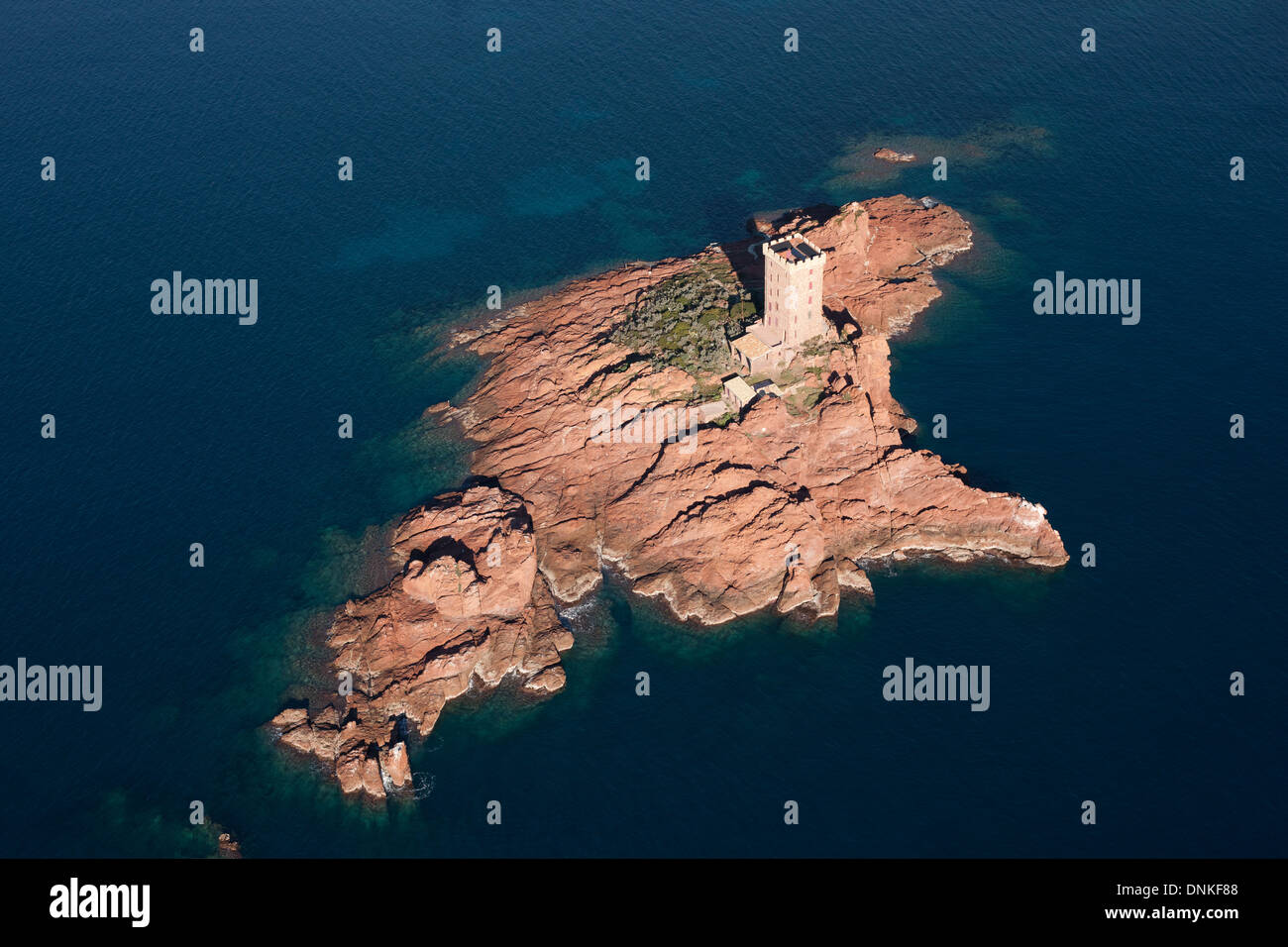 AERIAL VIEW. Castle on an island of volcanic red rock. Ile d'Or, Saint-Raphaël, Estérel Massif, Var, French Riviera, France. Stock Photo