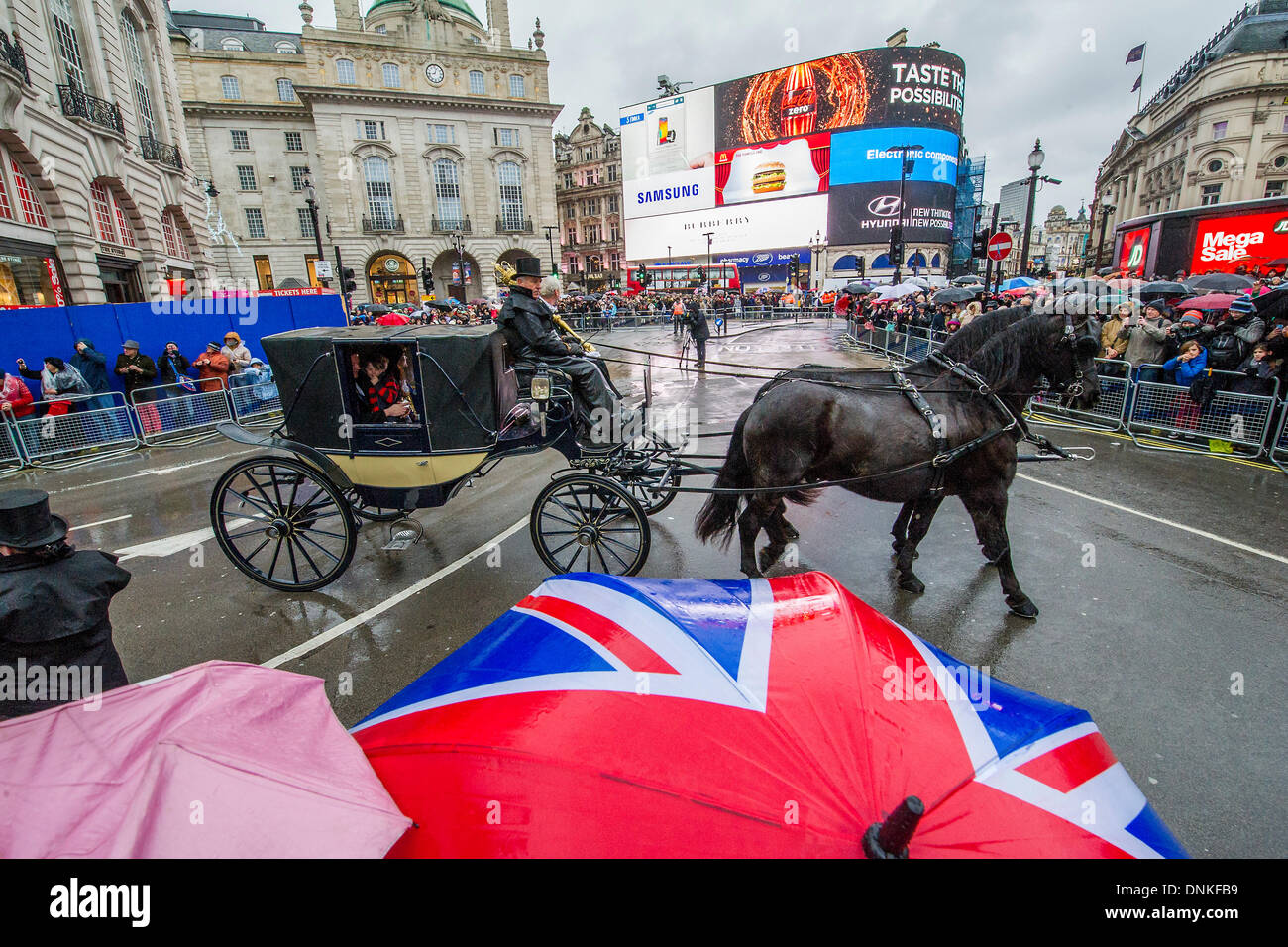 London, UK. 01st Jan, 2014. A new year's day parade passes through Piccadilly Circus on a wet and windy day. London, UK 01 Jan 2014. Credit:  Guy Bell/Alamy Live News Stock Photo