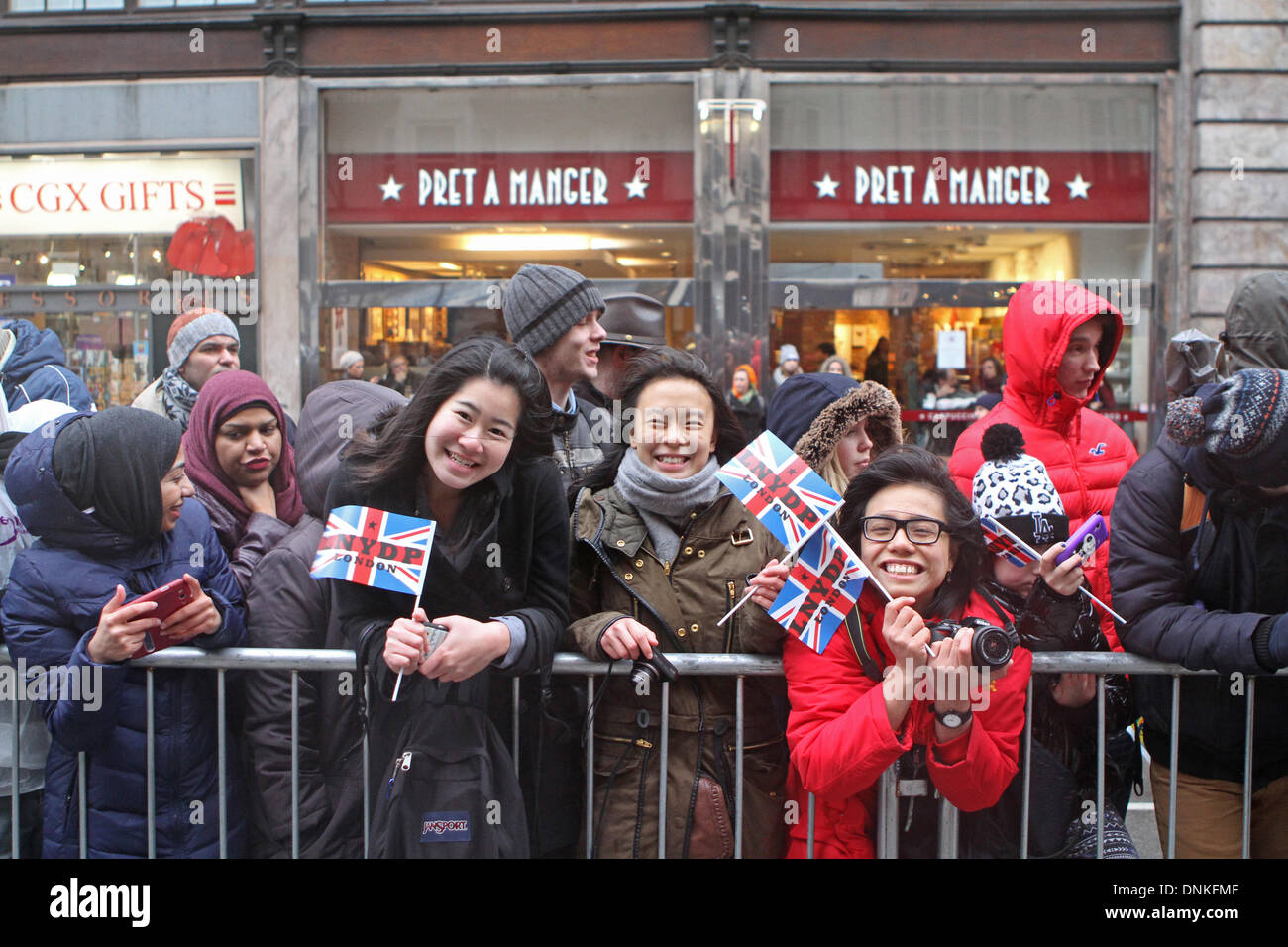 London,UK,1st January 2014,Crowds smile despite the rain waiting for the London's New Year's Day Parade 2014 Credit: Keith Larby/Alamy Live News Stock Photo