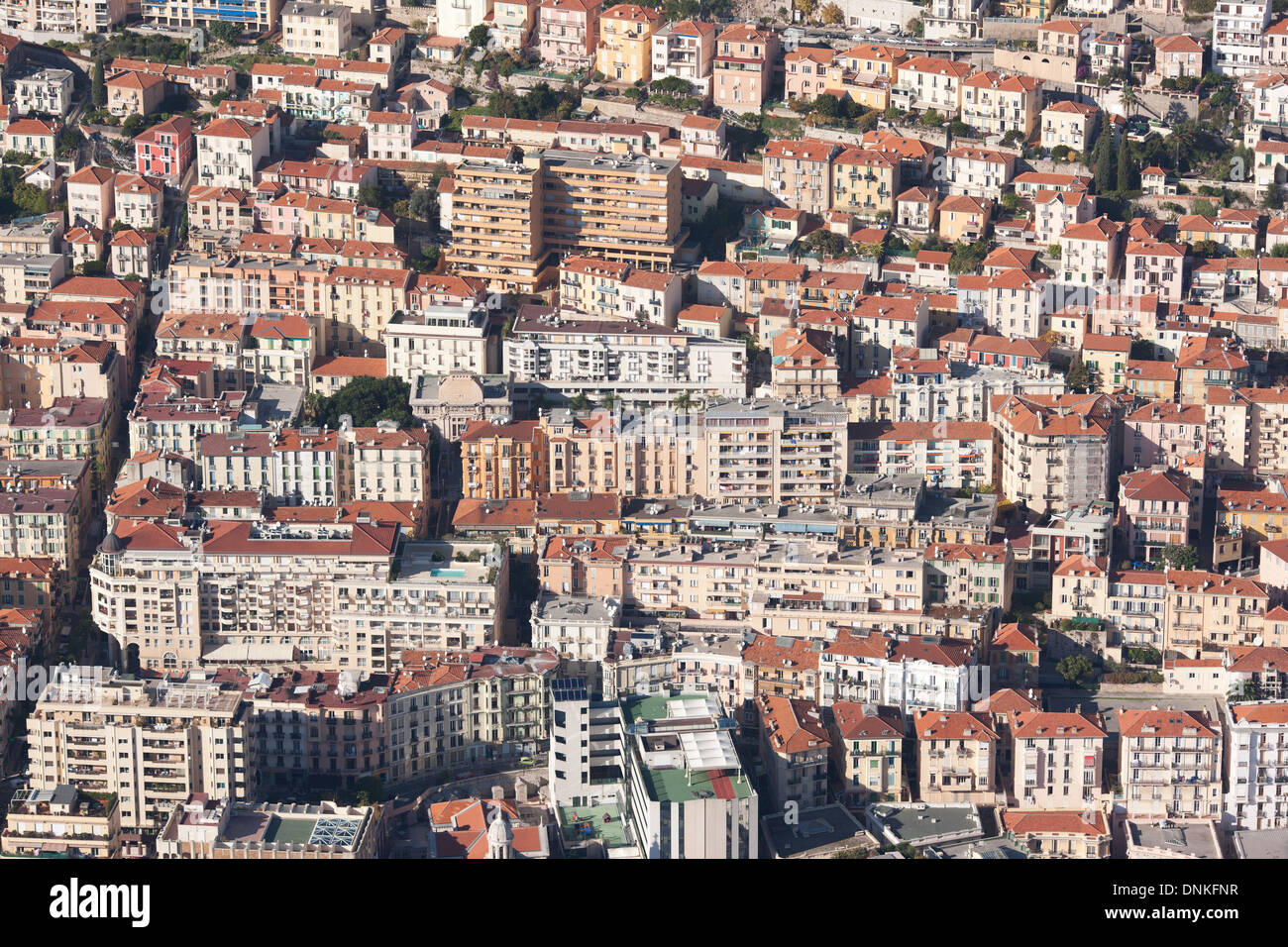 AERIAL VIEW. High density of apartment buildings on a steep hillside. Principality of Monaco (lowest half) and Beausoleil, France (highest half). Stock Photo