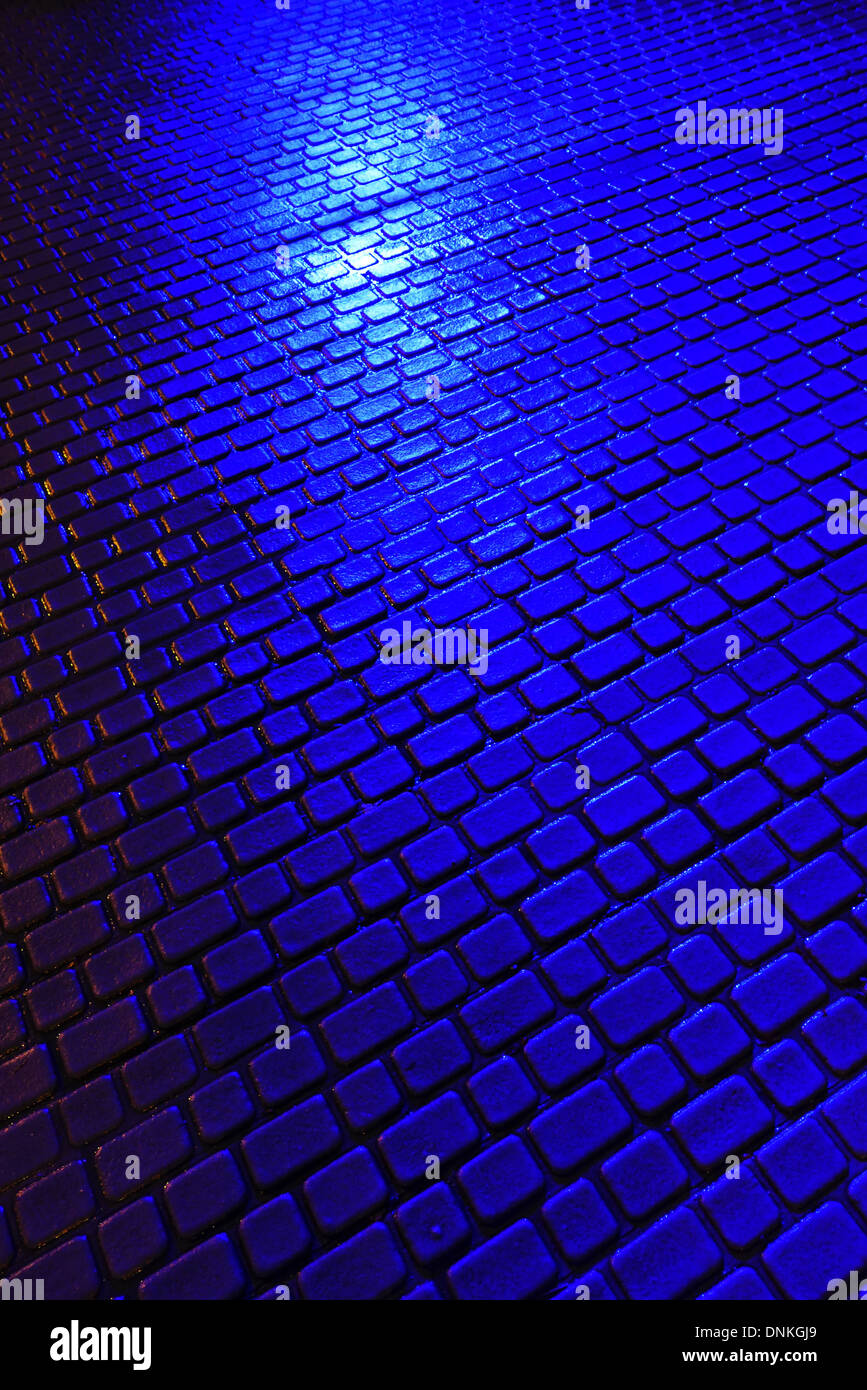 Pavement blocks in South Woodford, London E18, at night illuminated by blue light Stock Photo