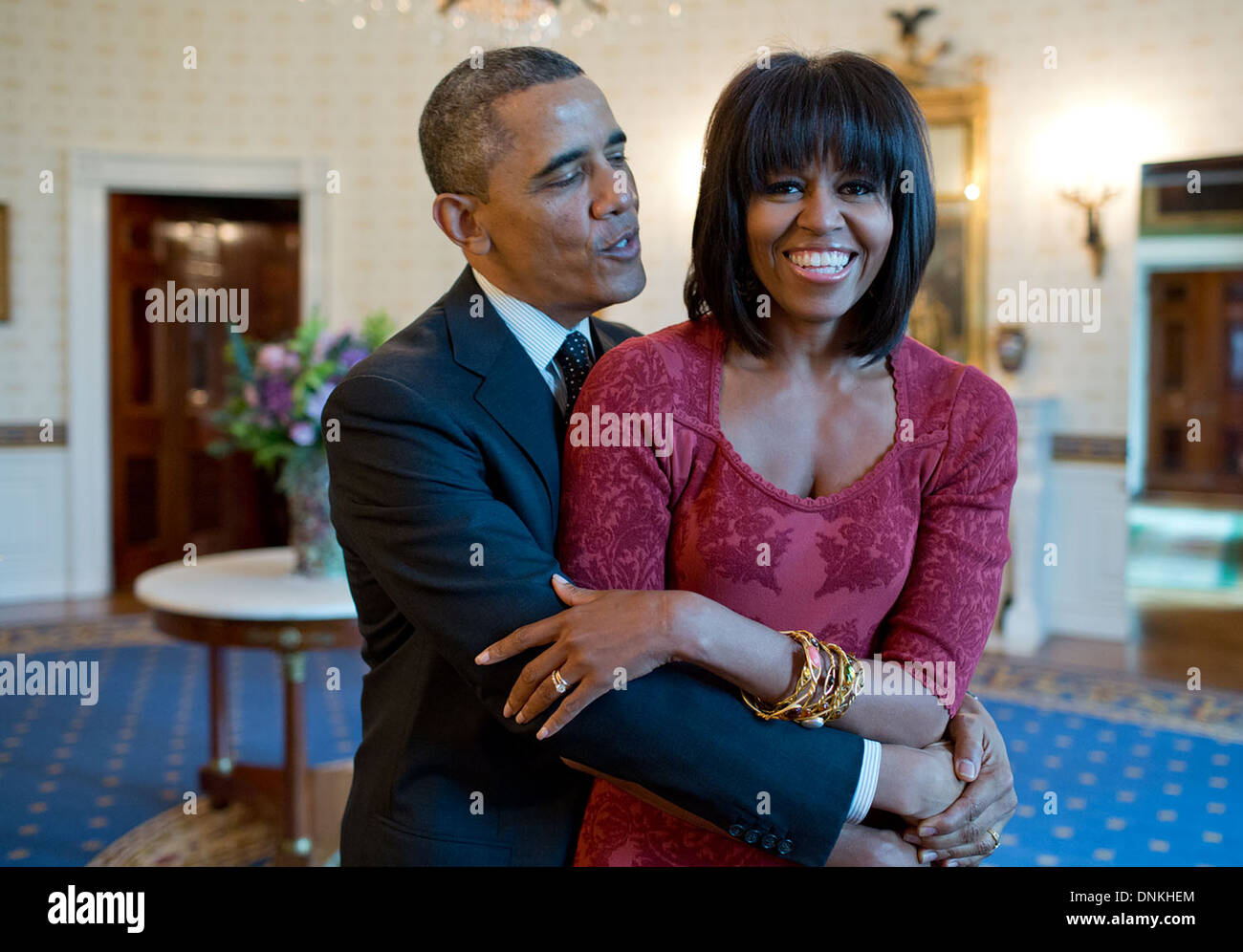 US President Barack Obama sings 'Happy Birthday' to First Lady Michelle Obama after greeting inaugural brunch guests in the Blue Room of the White House January 17, 2013 in Washington, DC. Stock Photo