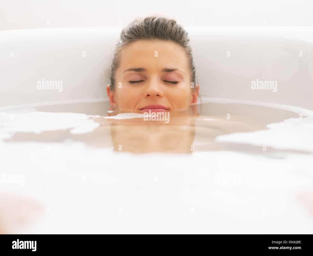 Young woman laying under water in bathtub Stock Photo Alamy