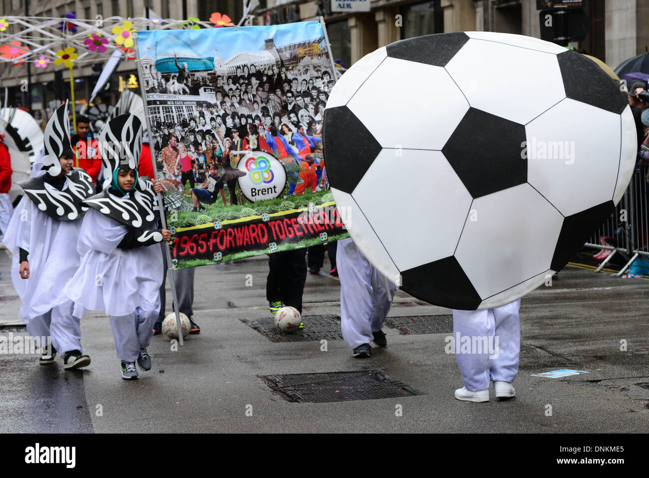London, UK. 1st January 2014. Tens of thousands of people braved dreadful weather in central London this afternoon for the capital's annual New Year's Day parade, January 1st 2014, Photo by See li/Alamy Live News Stock Photo