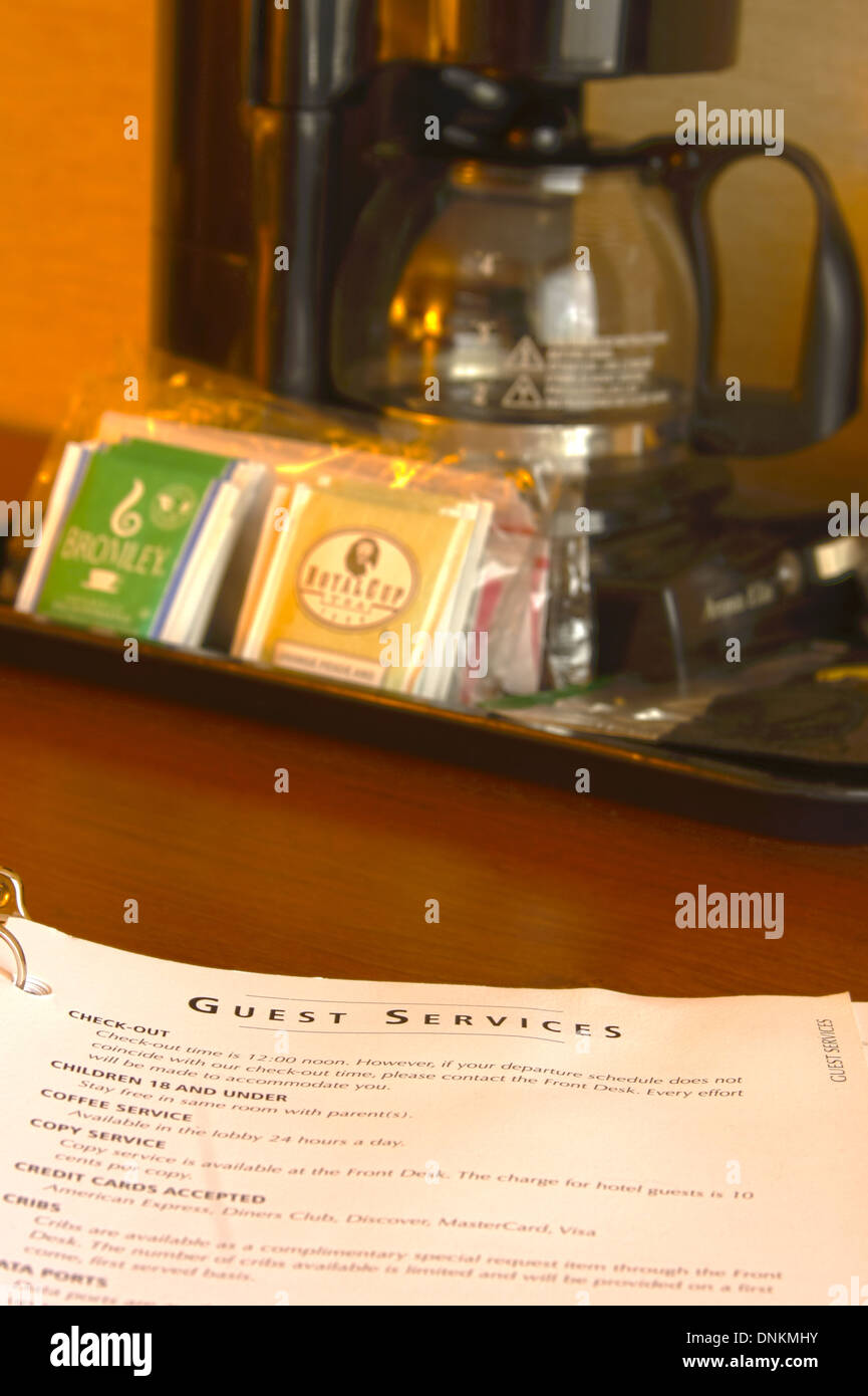 Guest Services brochure in a hotel room next to the coffee maker Stock Photo