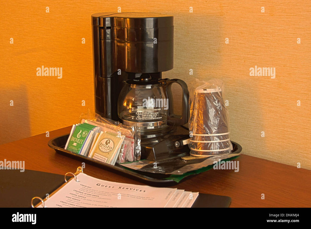 https://c8.alamy.com/comp/DNKMJ4/guest-services-brochure-in-a-hotel-room-next-to-the-coffee-maker-DNKMJ4.jpg