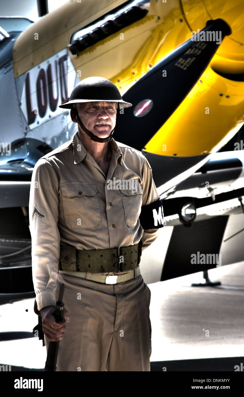 WW2 MD soldier guarding a warbird plane Stock Photo