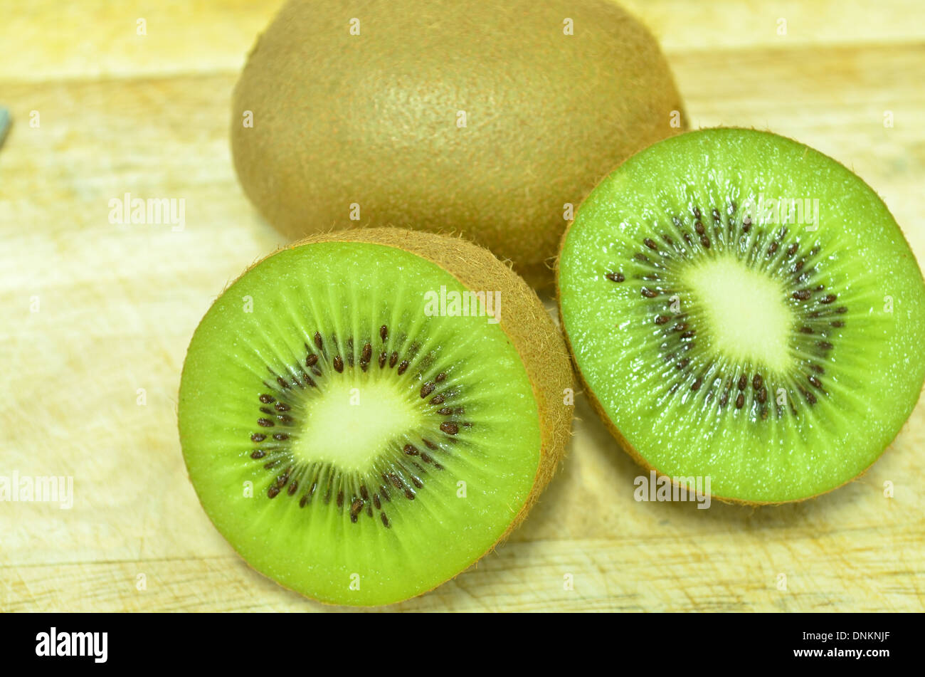 Whole kiwi fruit and his sliced segments isolated on white background Stock Photo