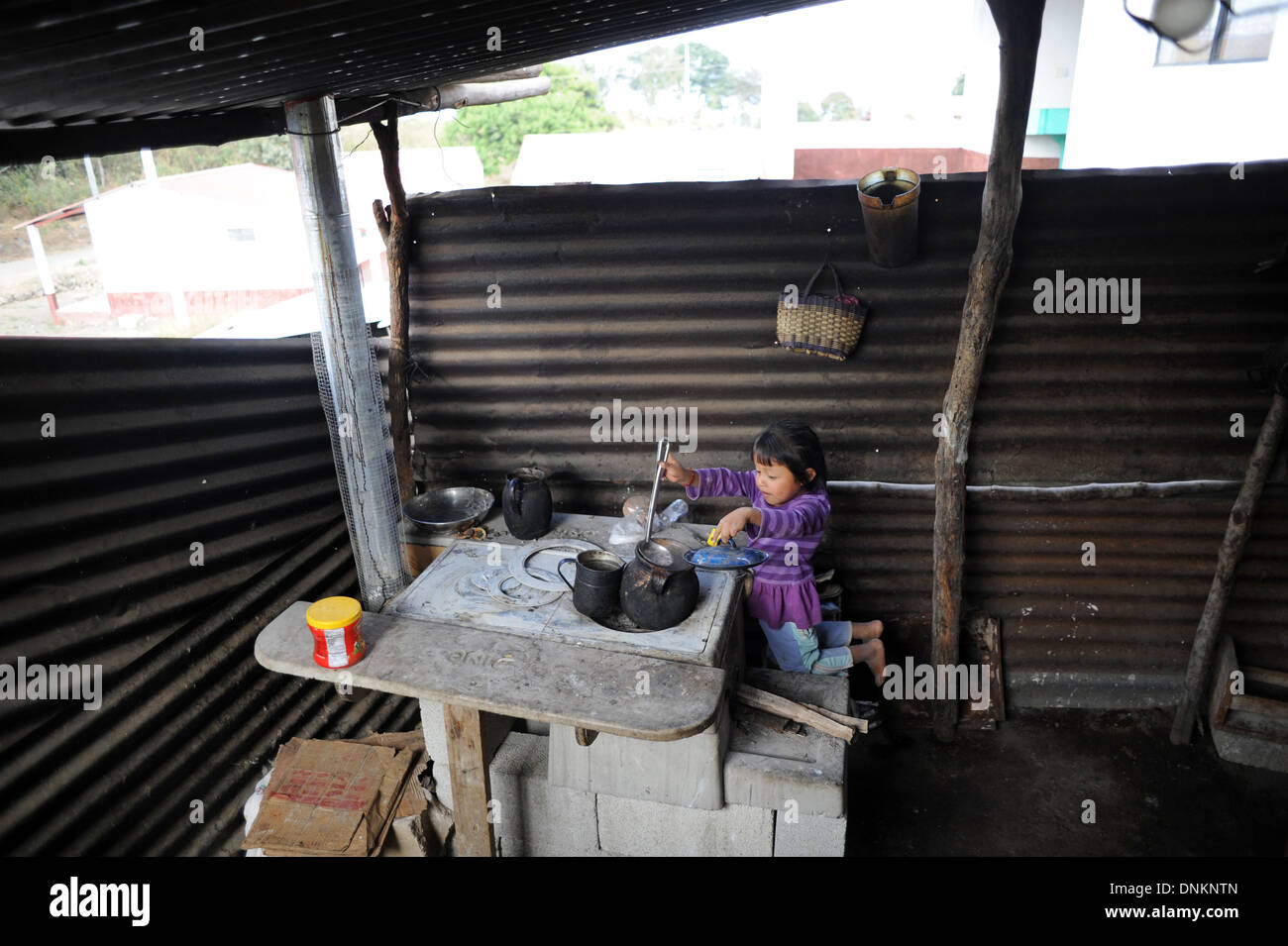 A Guatemalan girl cooks in the kitchen in Chuk Muk in Guatemala. Stock Photo