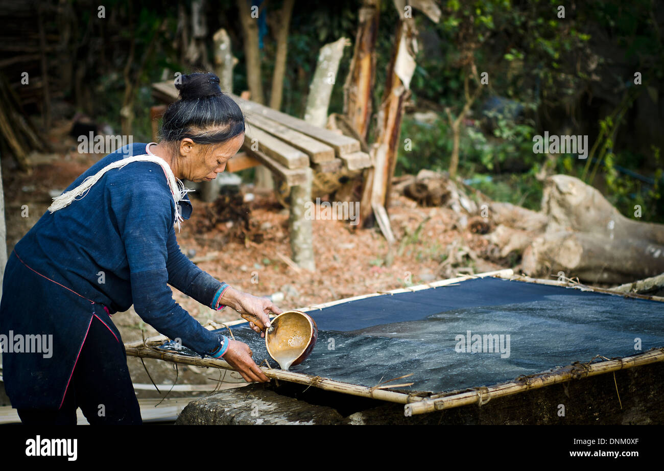 Laten tribe women making material for clothes  ,Pakha village ,Muang Sing , Laos Stock Photo