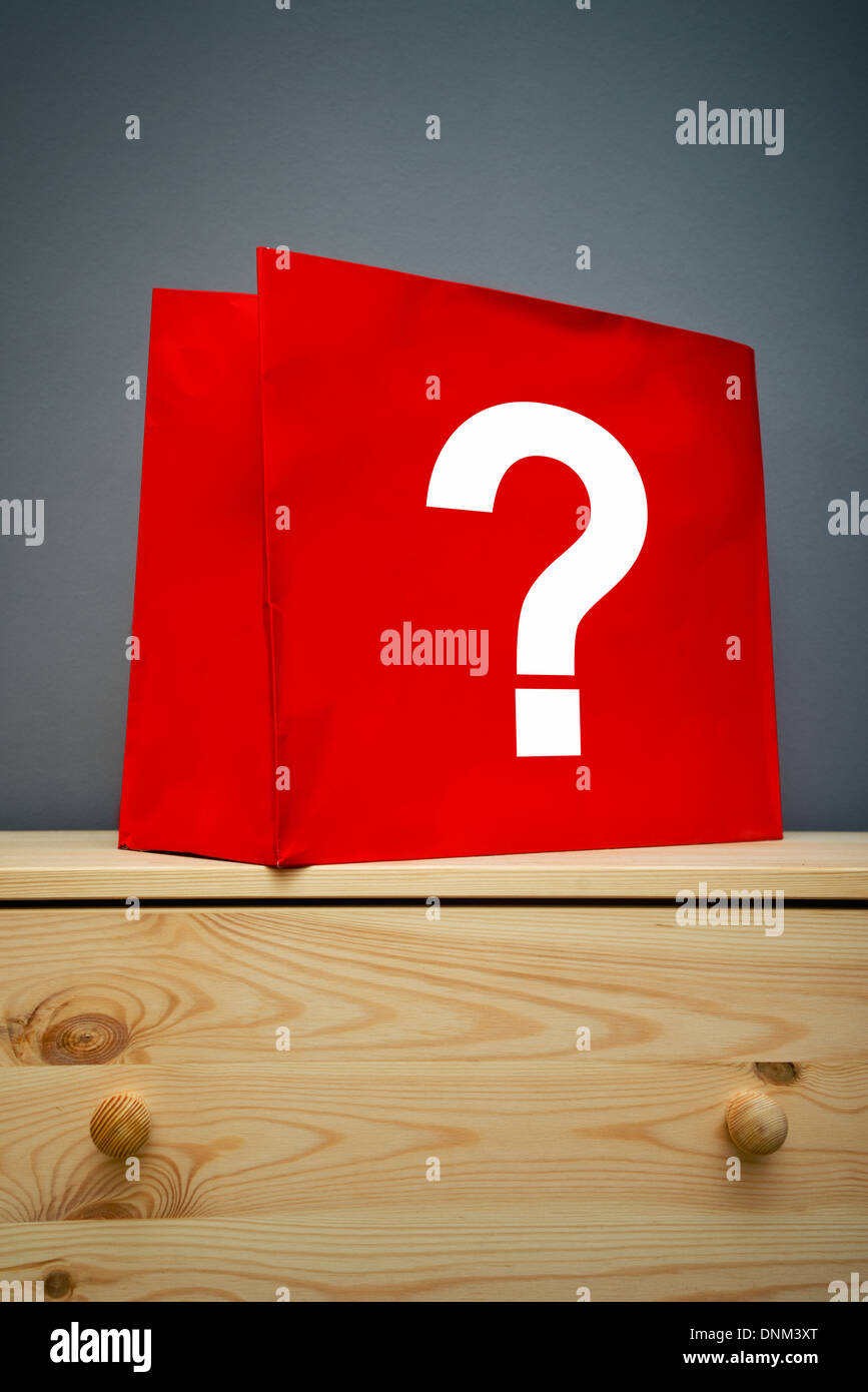 Red shopping bag with question mark on wooden Stock Photo Alamy