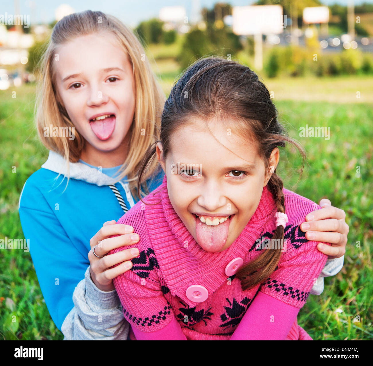 Little girls showing the tongue Stock Photo