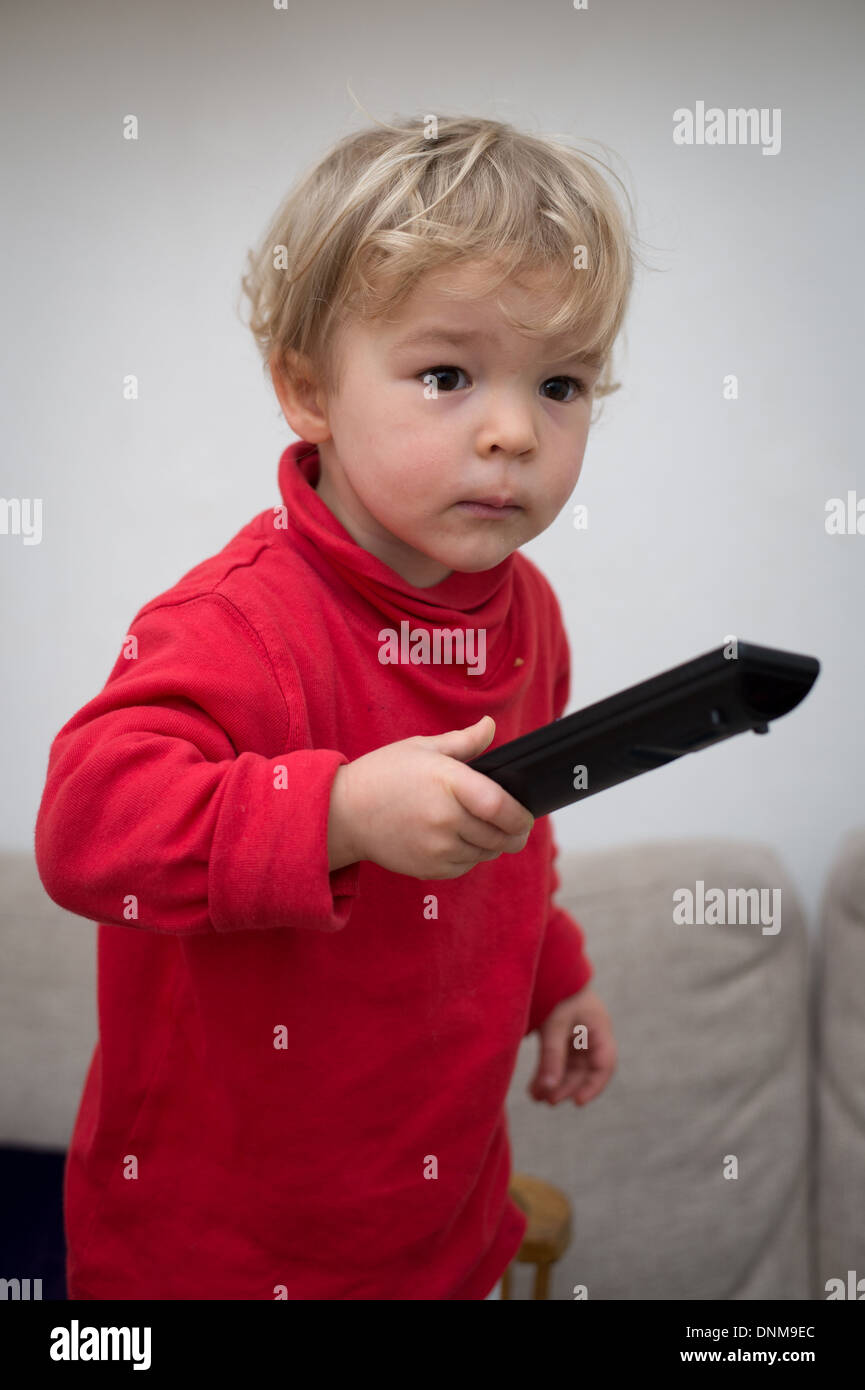 Berlin, Germany, a 2 year old girl with a remote control Stock Photo