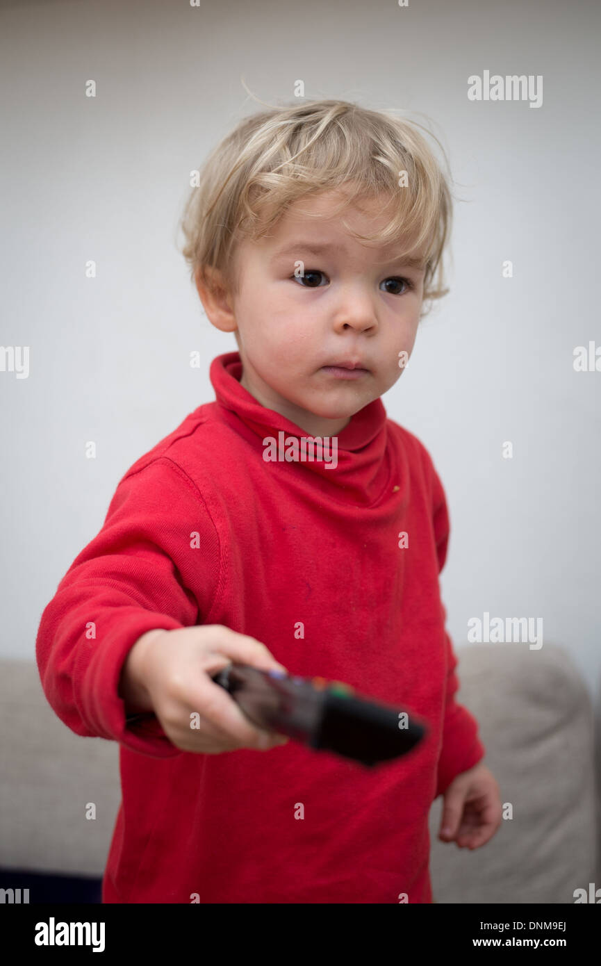 Berlin, Germany, a 2 year old girl with a remote control Stock Photo