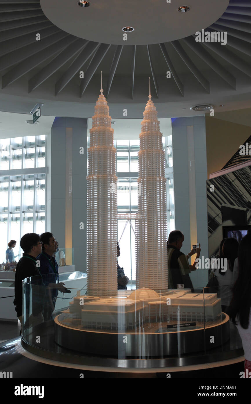 A photograph of a model of the Petronas Towers in Kuala Lumpur, Malaysia. The model is located on the top floor of the building. Stock Photo
