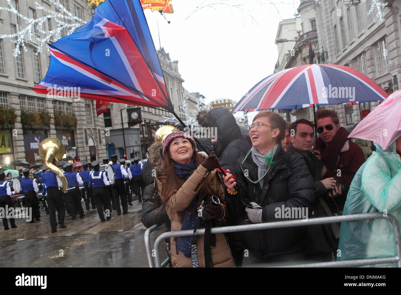 London,UK,1st January 2014,Strong winds blew umbrellas inside out at the London's New Year's Day Parade 2014 Credit: Keith Larby/Alamy Live News Stock Photo