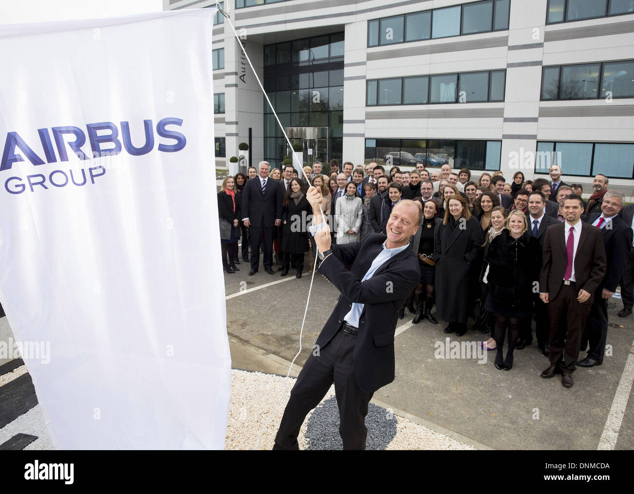 (140102) -- TOULOUSE, Jan. 2, 2014 (Xinhua) -- File photo taken on Dec. 18, 2013 shows Tom Enders, CEO of Airbus Group, raising a flag with a new logo in front of Airbus Group Headquarters in Toulouse, France. European aerospace giant Aeronautic, Defense and Space Corporation (EADS) on Jan. 1 formally renamed itself after its flagship brand, Airbus, in an attempt to streamline the company's structure and boost the predominance of commercial aeronautics. (Xinhua) Stock Photo