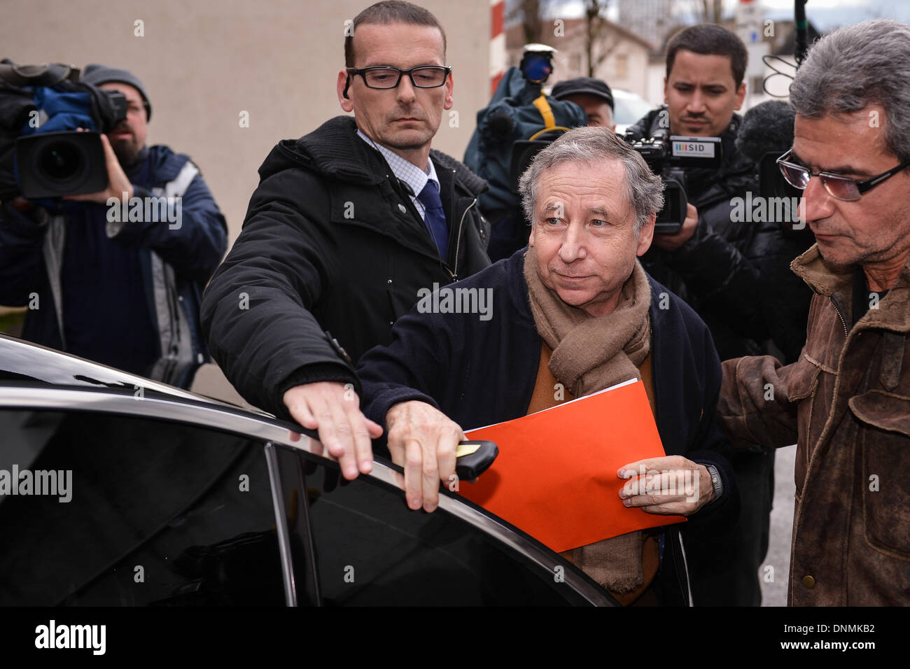 Grenoble, France. 02nd Jan, 2014. President of the Federation Internationale de l'Automobile (F.I.A.) Jean Todt (C) returns to the 'Centre Hospitalier Universitaire' (CHU) hospital in Grenoble, near the French Alps, France, 02 January 2014. Retired Formula One German racing driver Michael Schumacher is still in a critical condition, after he underwent emergency surgery after being admitted in a coma with a cranial trauma following a ski accident in Meribel, according to the hospital in Grenoble. Photo: David Ebener/dpa/Alamy Live News Stock Photo